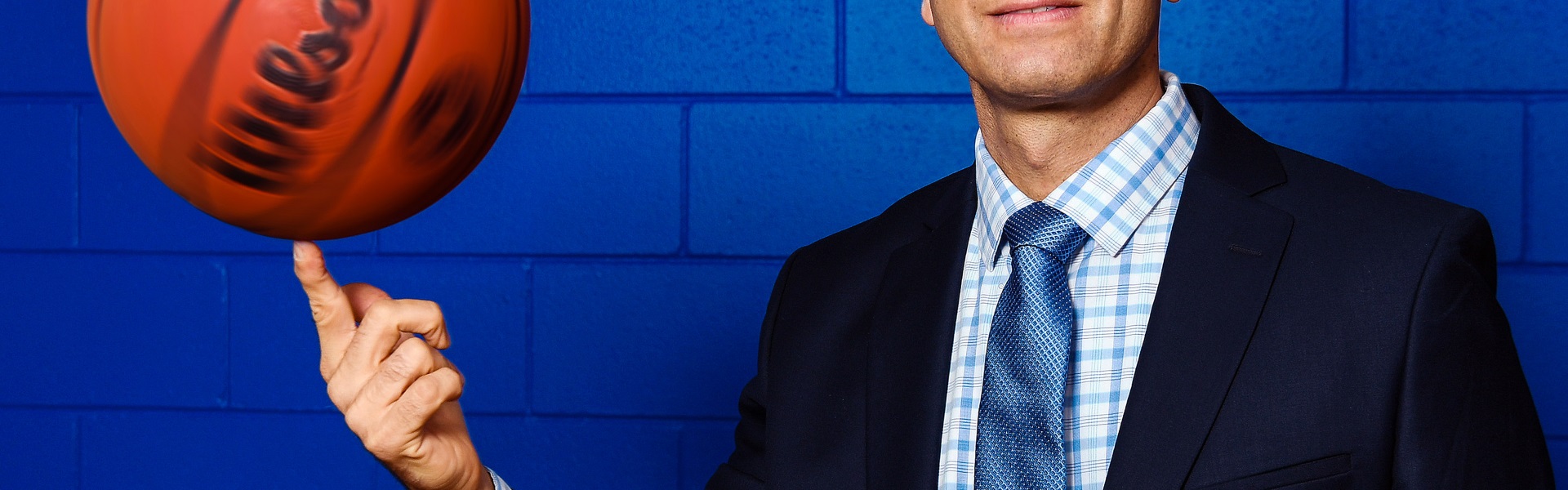 Coach of the Breakers spinnig ball on finger, neck down/mid shot